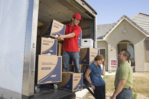 Packing boxes labeled for different rooms in a new home